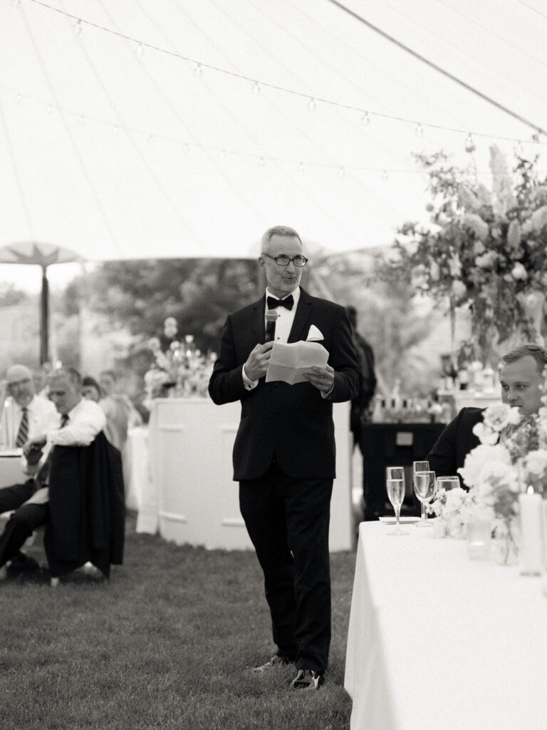 Black and white photo of the father of the bride giving a speech