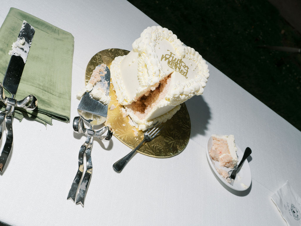 Flash photo of a cut into cake with a slice on a plate next to it
