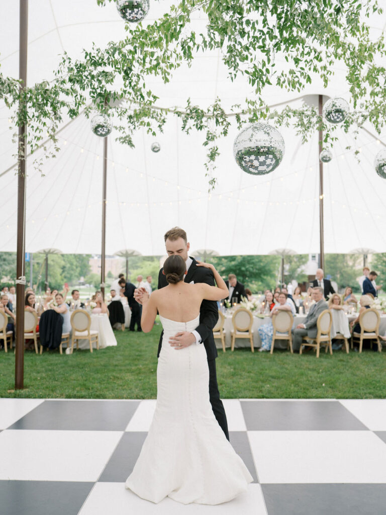 Bride and groom dancing surrounded by guests under hanging disco balls at Saint Mary’s Notre Dame wedding – Cynthia Mae Photo.