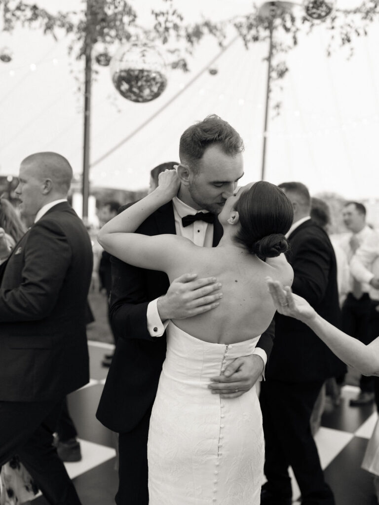 Bride and groom kissing on the dance floor