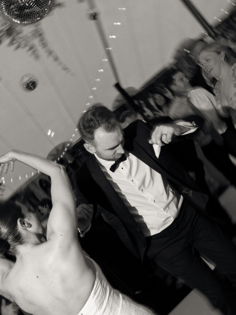 Black and white photo of a bride and groom dancing