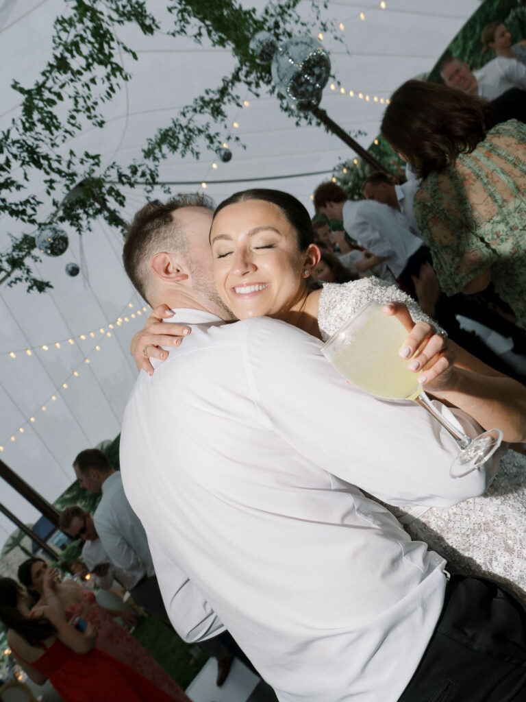 Bride and groom hugging on the dance floor