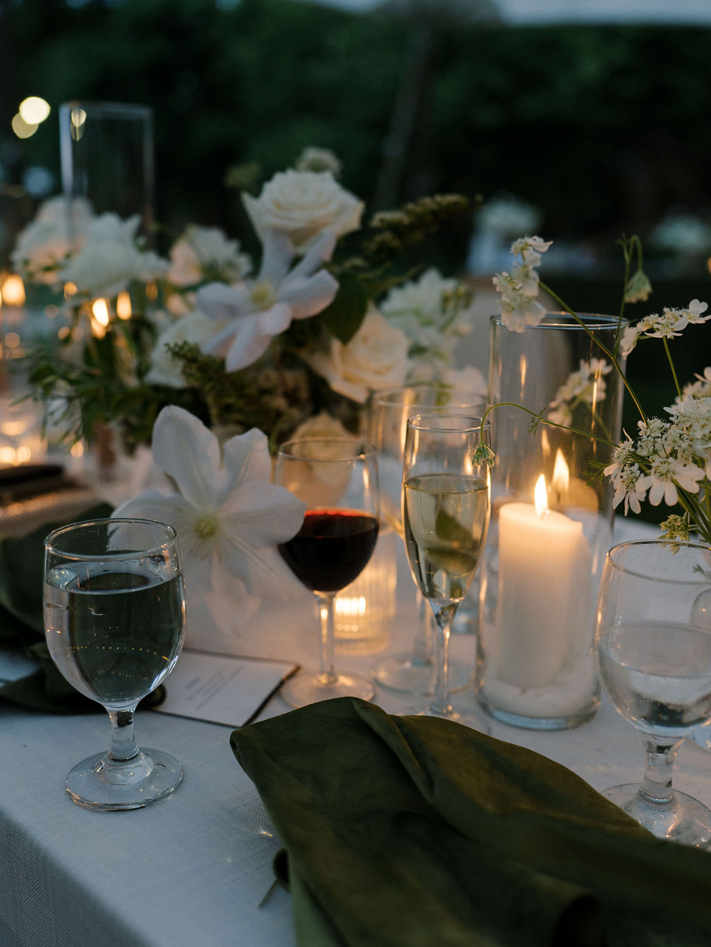 Candles glowing among white floral centerpieces at Saint Mary’s Notre Dame wedding reception table – Cynthia Mae Photo.