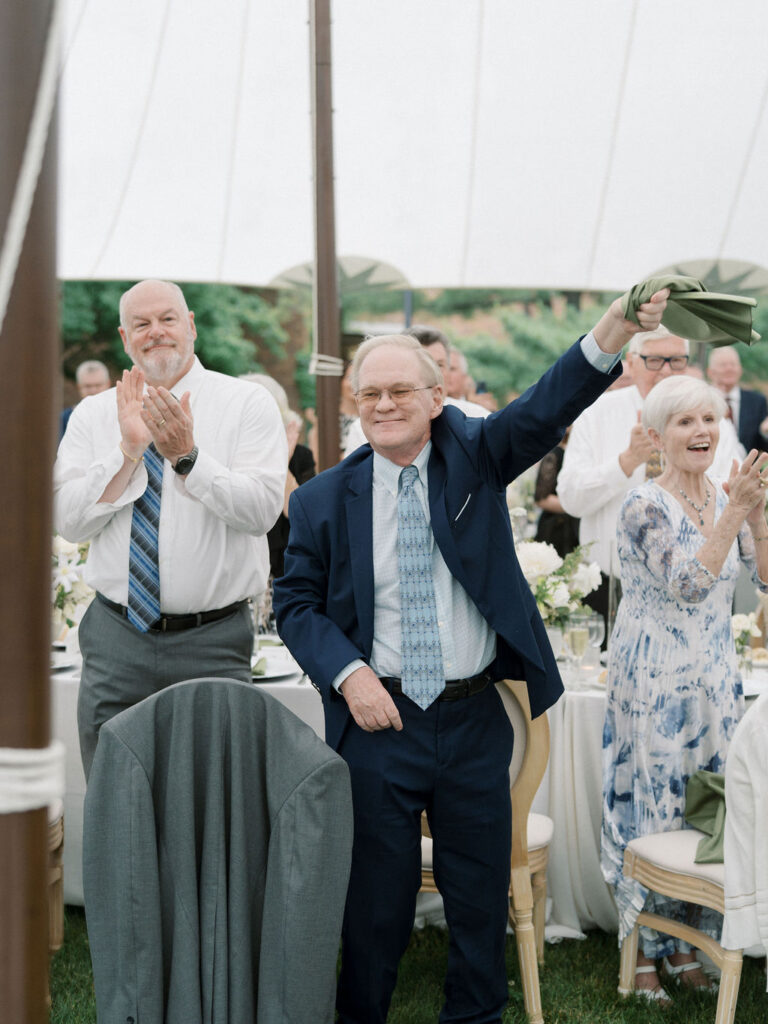 Guests clapping as the bride and groom enter the reception