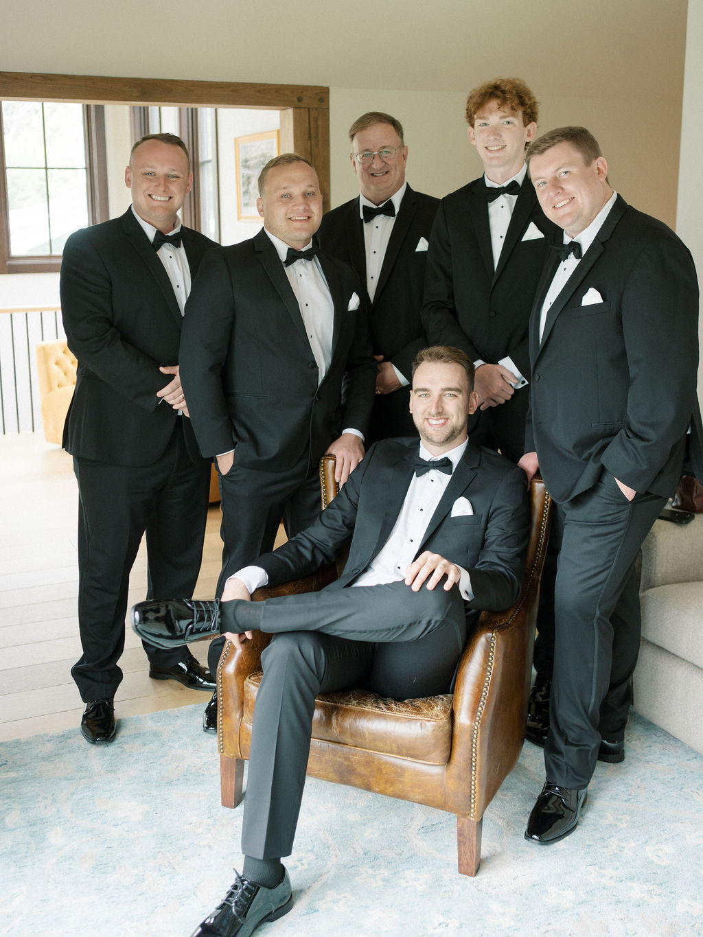 Groom and groomsmen in black tuxedos posing in natural light before Saint Mary’s Notre Dame wedding ceremony – Cynthia Mae Photo.