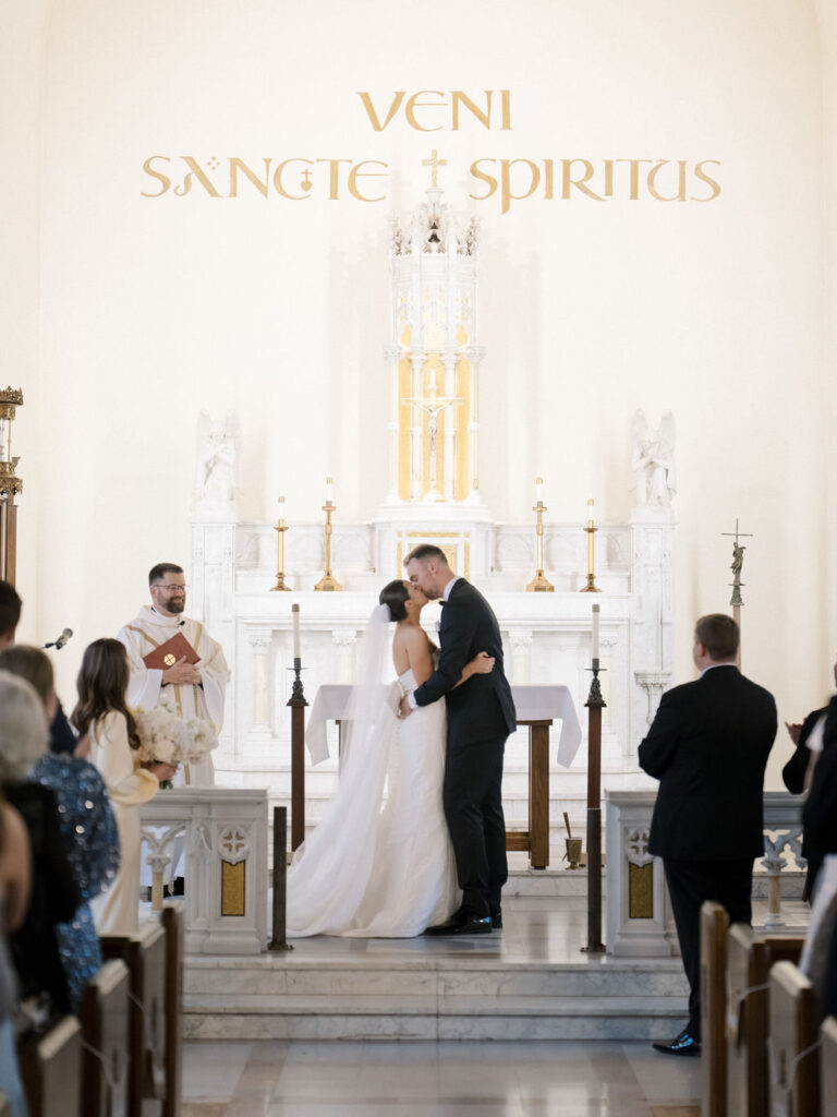 Bride and groom kissing at the end of their wedding ceremony