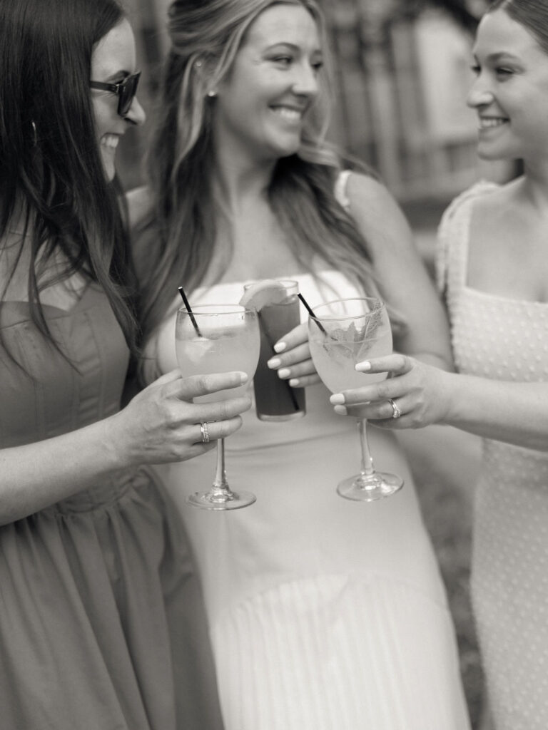 Black and white photo of guests enjoying drinks during cocktail hour