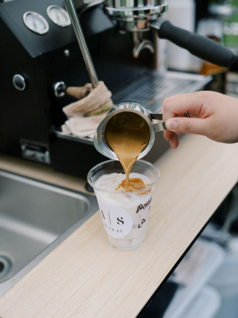 Barista pouring a coffee from Clique Coffee Catering espresso bar during cocktail hour at Saint Mary’s Notre Dame wedding – Cynthia Mae Photo.
