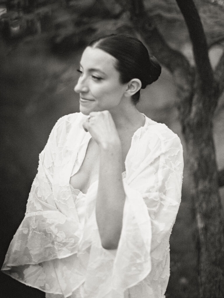 Black and white portrait of bride in robe outdoors before Saint Mary’s Notre Dame wedding – film image by Cynthia Mae Photo.