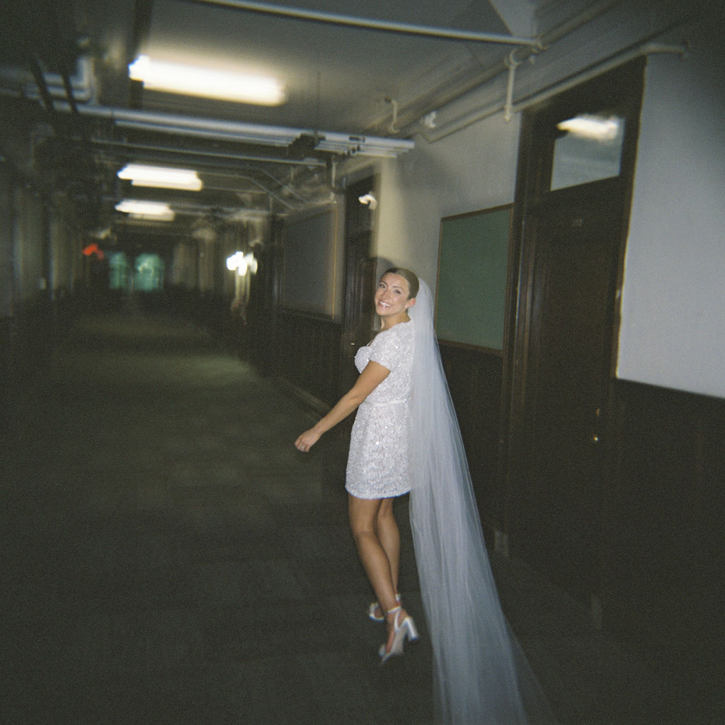 Bride walking down the hallway after changing into her reception dress