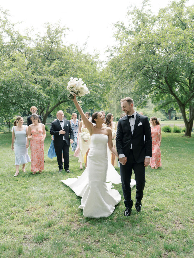 Bride laughing and holding bouquet during candid wedding party portraits at Saint Mary’s Notre Dame wedding – Cynthia Mae Photo.