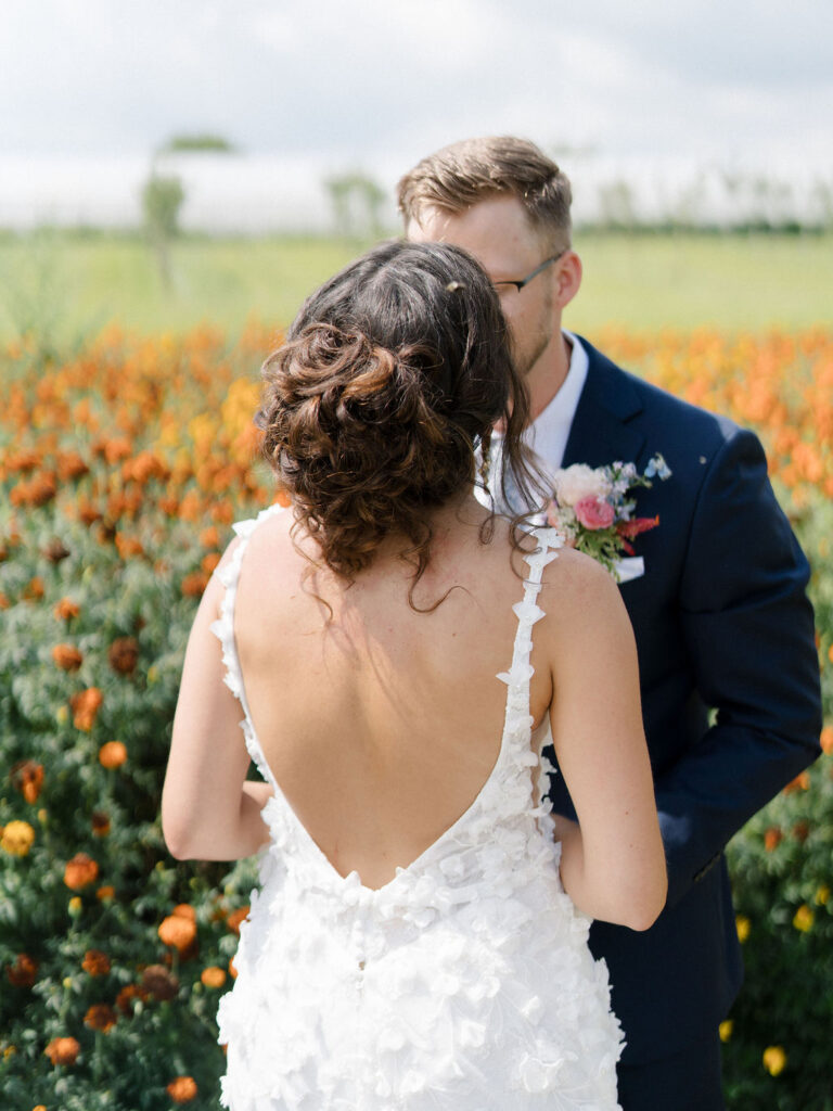 Couple kissing in the gardens after reading their private vows at Of The Land wedding venue.
