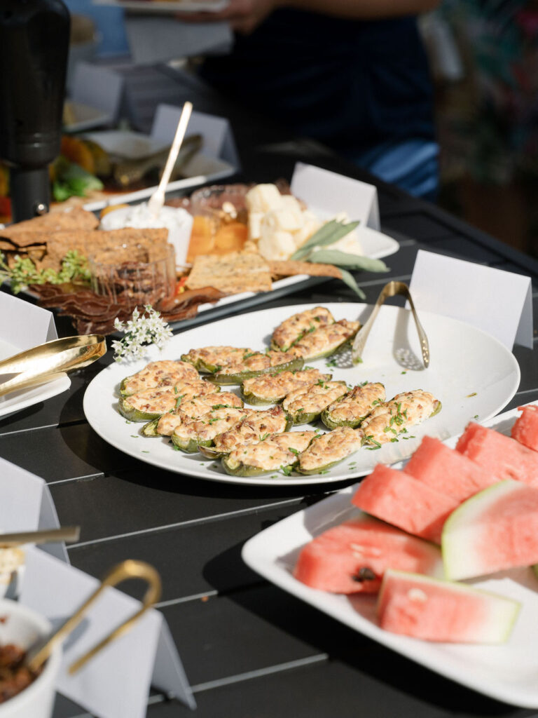 Stuffed jalapeños, cheese board, and watermelon slices served during Of The Land wedding cocktail hour.