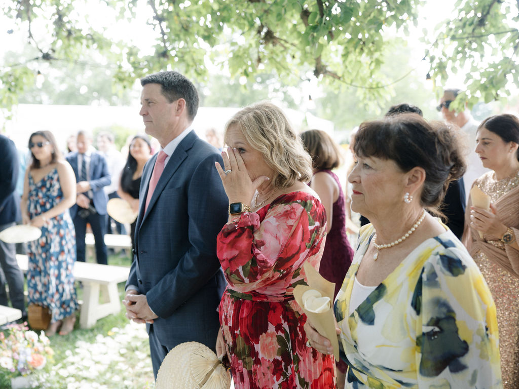 Guests getting emotional during the outdoor summer wedding ceremony.