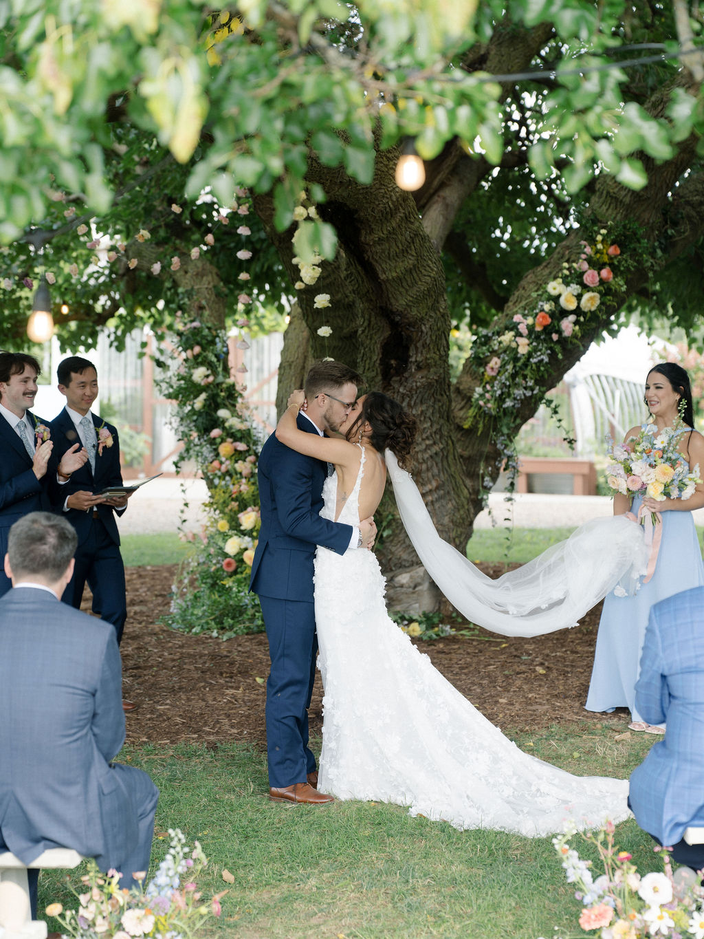Couple sharing their first kiss beneath the branches of the Mulberry tree.