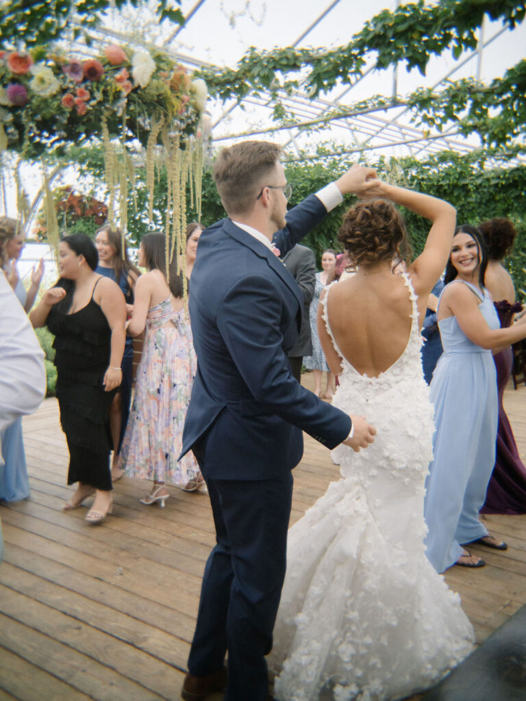 Groom twirling the bride during their reception entrance.