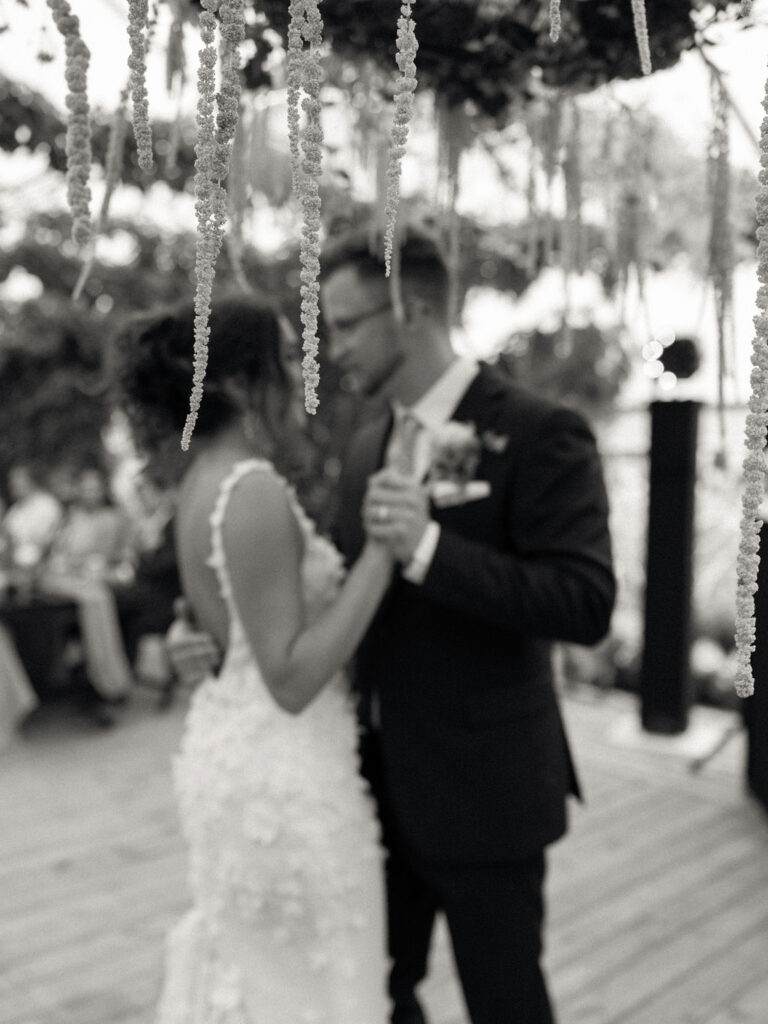 Black-and-white photo of the couple dancing during their first dance at their Of The Land wedding reception.