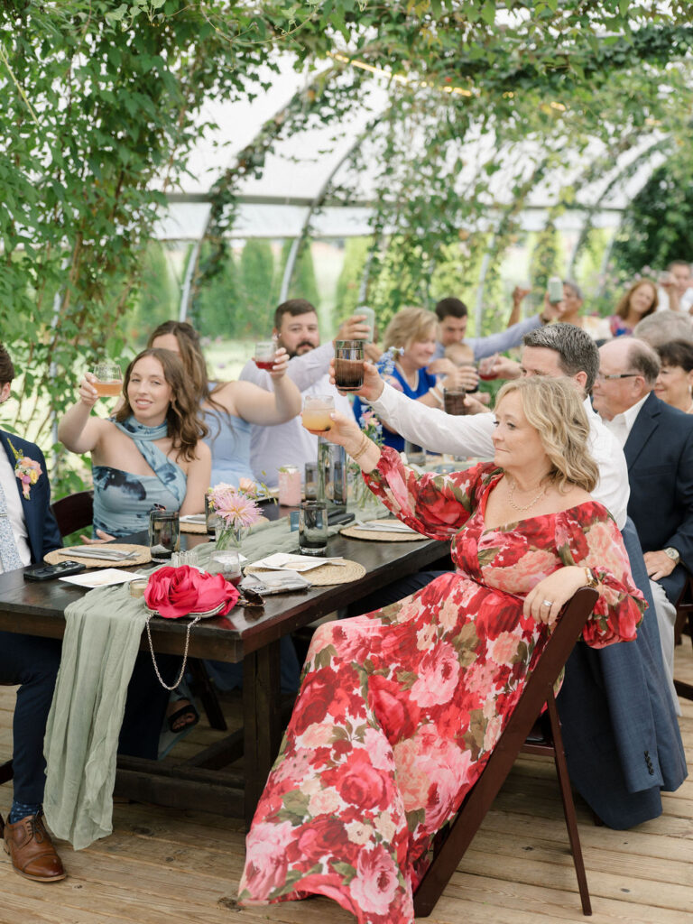 Guests toasting their cocktails during speeches.