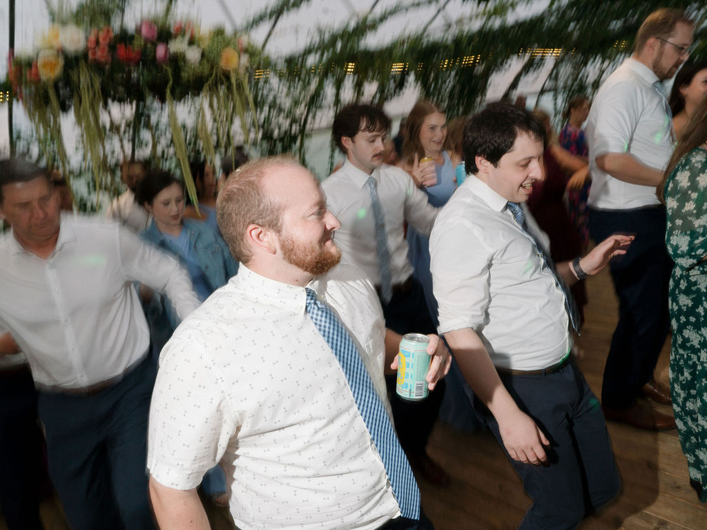 Guests having drinks and dancing during an Of The Land wedding reception.