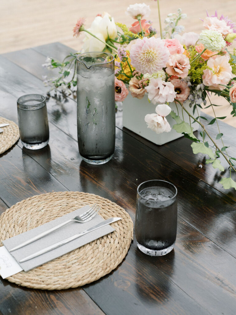Water glasses and florals on the farm style tables at Of The Land wedding venue in Michigan.