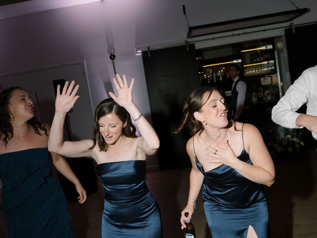 Bridesmaids dancing during open dancing.
