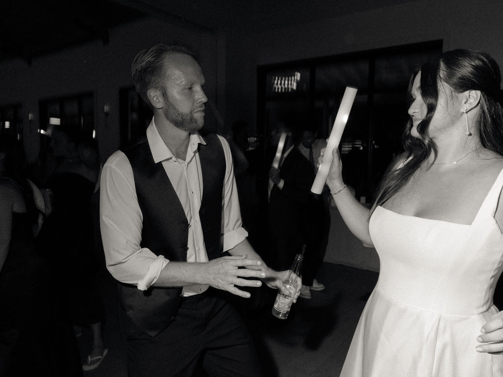 Black and white photo of a bride and groom dancing during their reception.