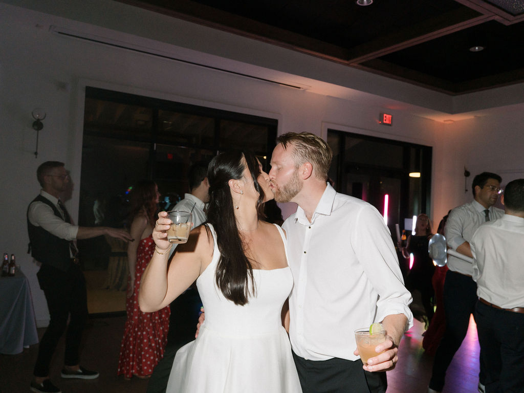 Bride and groom kissing during their wedding reception.