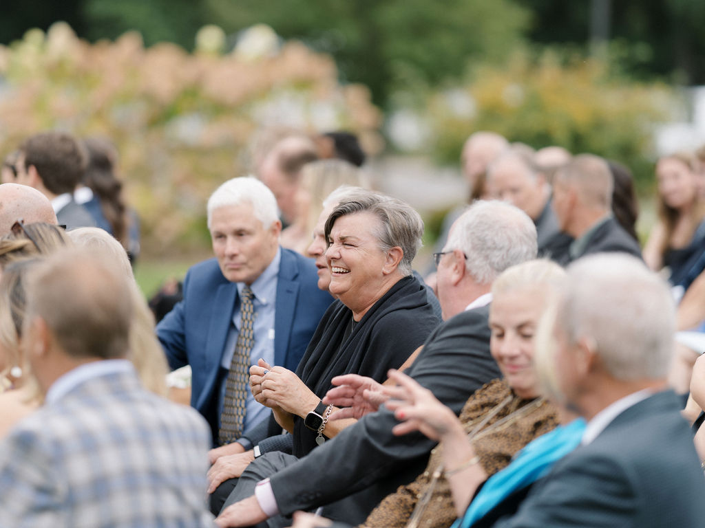 Candid photo of guests mingling as they wait for the ceremony to start.