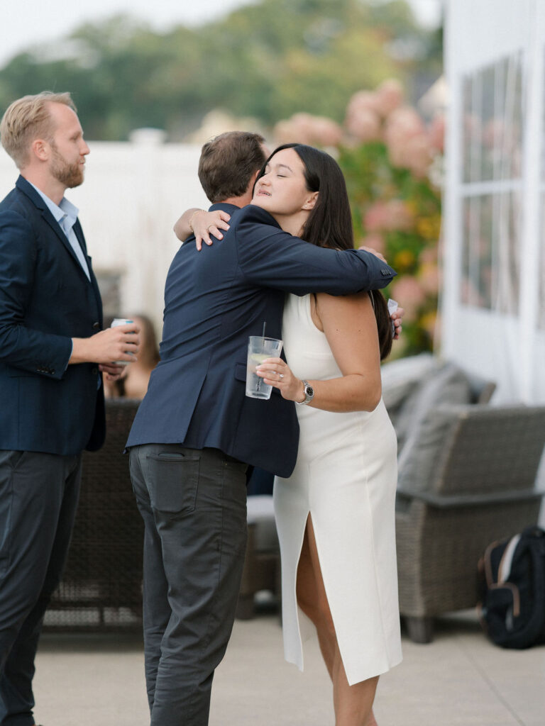 Bride hugging a guest during speeches.