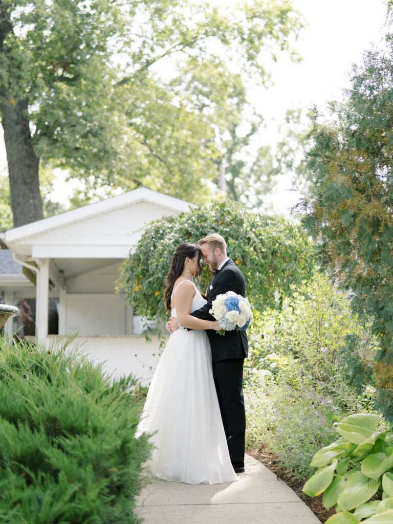 Bride and groom posing during their Bay Pointe Woods wedding.